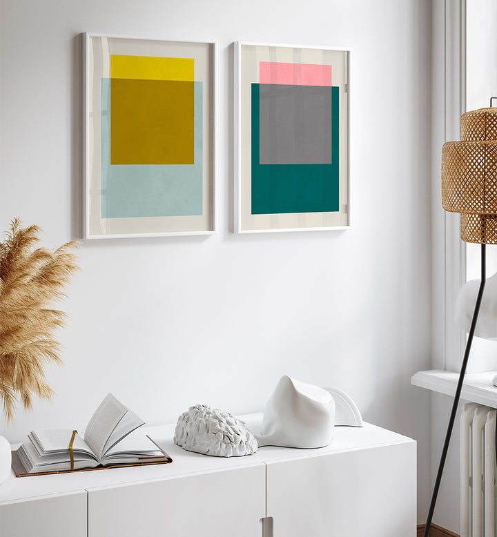 Modern interior with abstract art on the wall, a white cabinet, and decorative items.