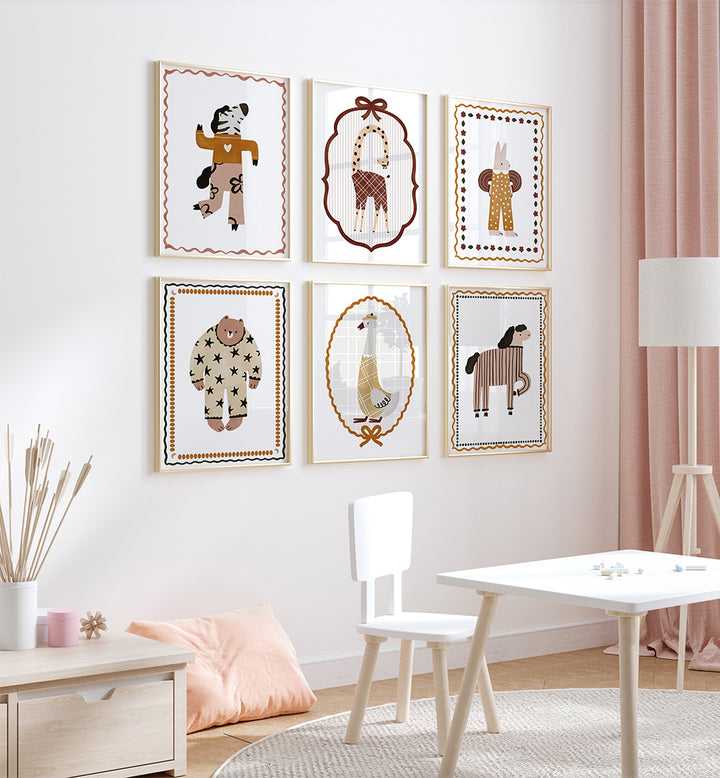 Children's room with framed illustrations on the wall and a small table and chair set.