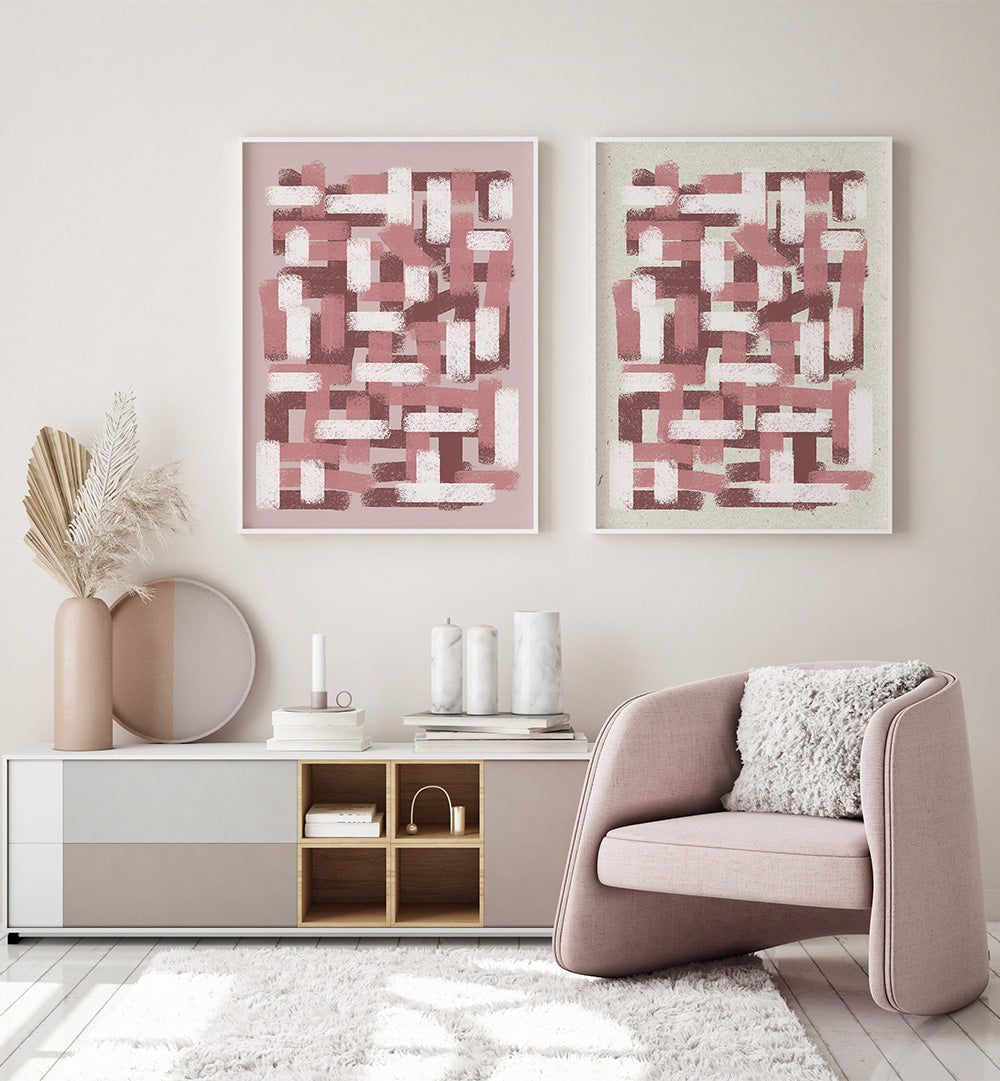 Modern living room with abstract pink artworks, a beige armchair, and decorative items.