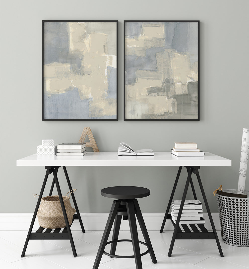 Modern interior with a white desk, black stool, and abstract wall art.