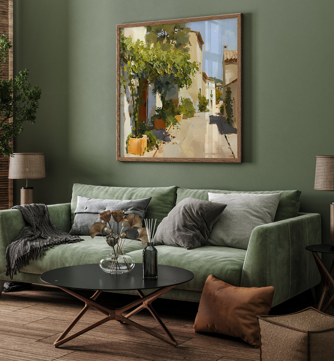 Stylish living room featuring STREET IN MALLORCA III artwork above a cozy green sofa, blending elegance and functionality.