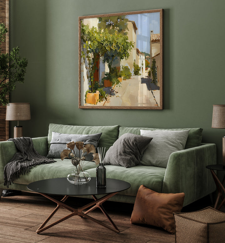 Stylish living room featuring STREET IN MALLORCA III artwork above a cozy green sofa, blending elegance and functionality.