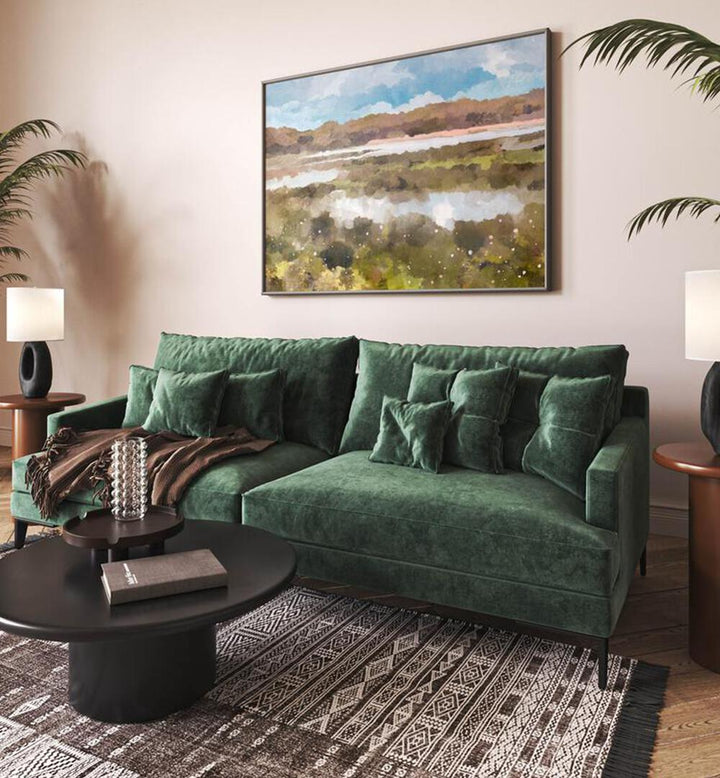 Transform your space with THE LOOKOUT, LANDSCAPE PAINTINGS, showcasing nature's beauty above a cozy green sofa.