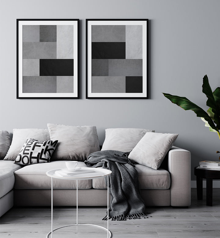 Modern living room with a gray sofa, abstract art on the wall, and a clear side table.