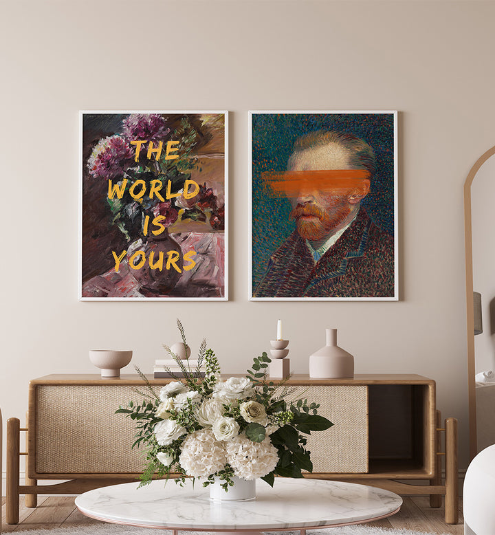 Two framed artworks on a wall above a wooden console table with decorative items.