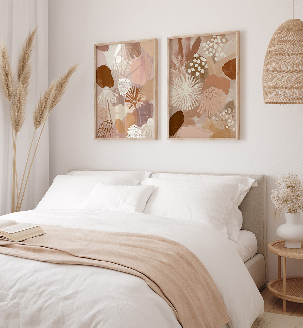 Neatly made bed with white bedding and a beige throw blanket, framed abstract art on the wall.