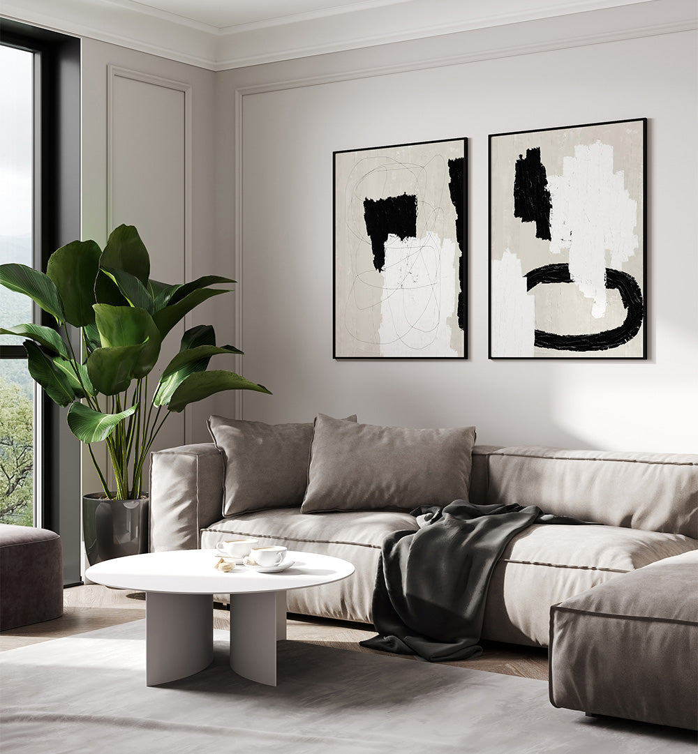 Modern living room with a gray sectional sofa, abstract art on the wall, and a plant.