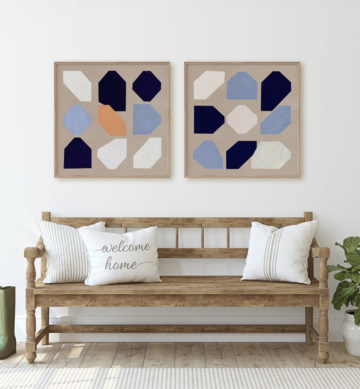 Wooden bench with decorative pillows and framed geometric art in a room.