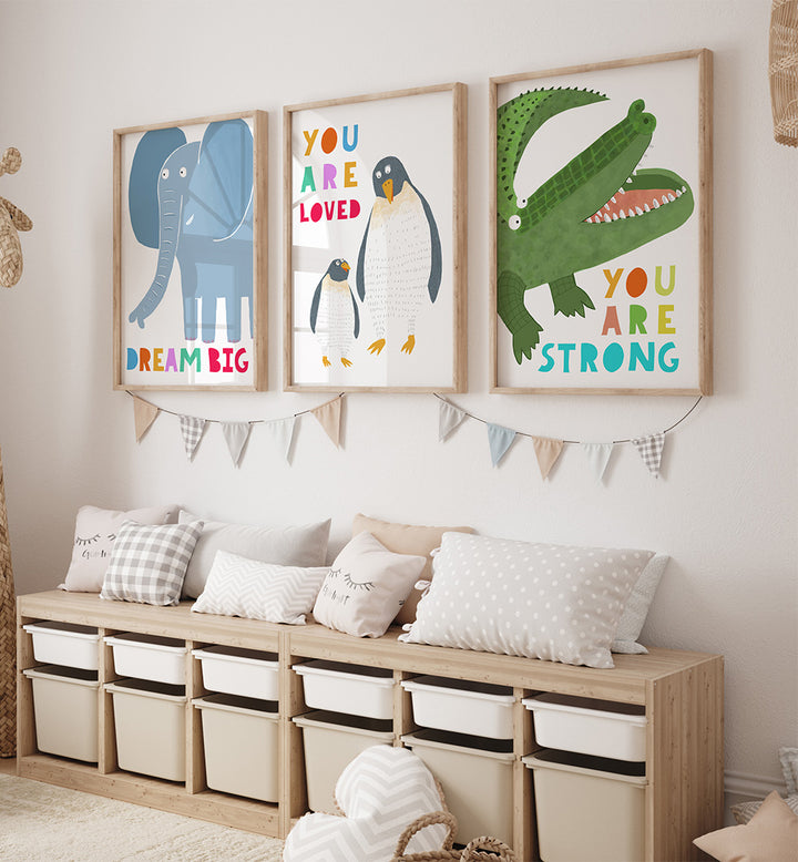 Children's room with framed illustrations of an elephant, penguin, and crocodile on the wall.