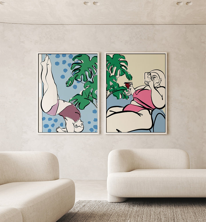 Two abstract art prints of women in swimsuits hanging on a wall above a sofa.