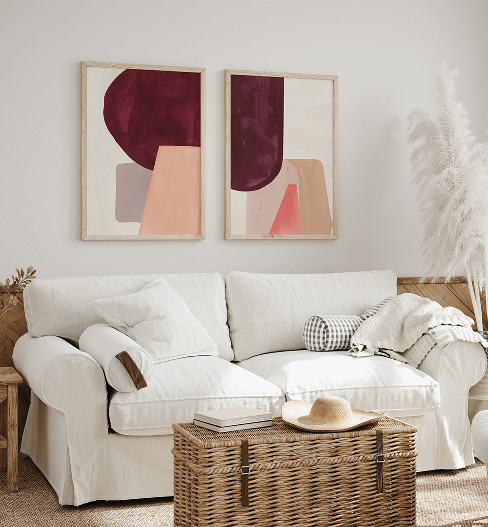 Living room with a white sofa, abstract art on the wall, and a woven coffee table.