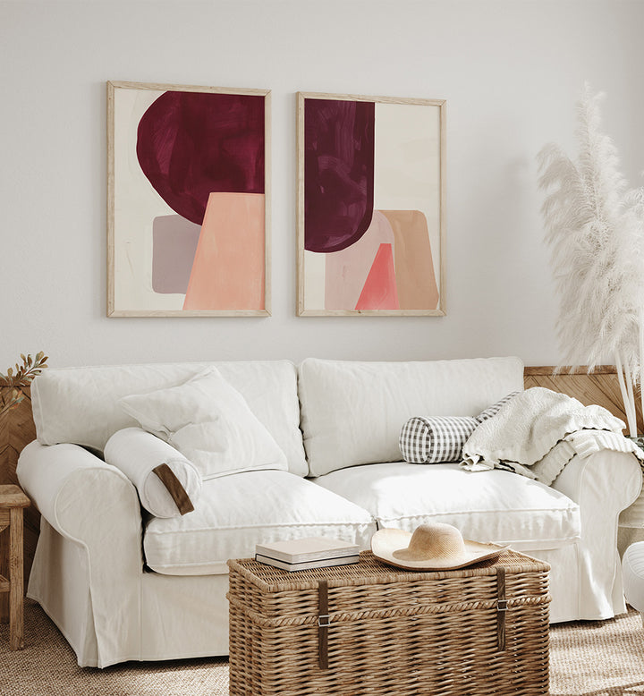 Living room with a white sofa, abstract art on the wall, and a woven coffee table.