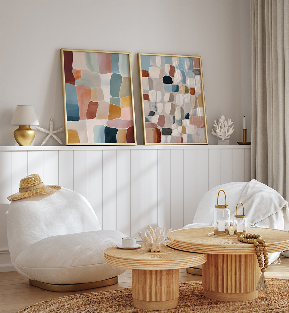 Modern living room with abstract art, white chairs, and wooden tables.