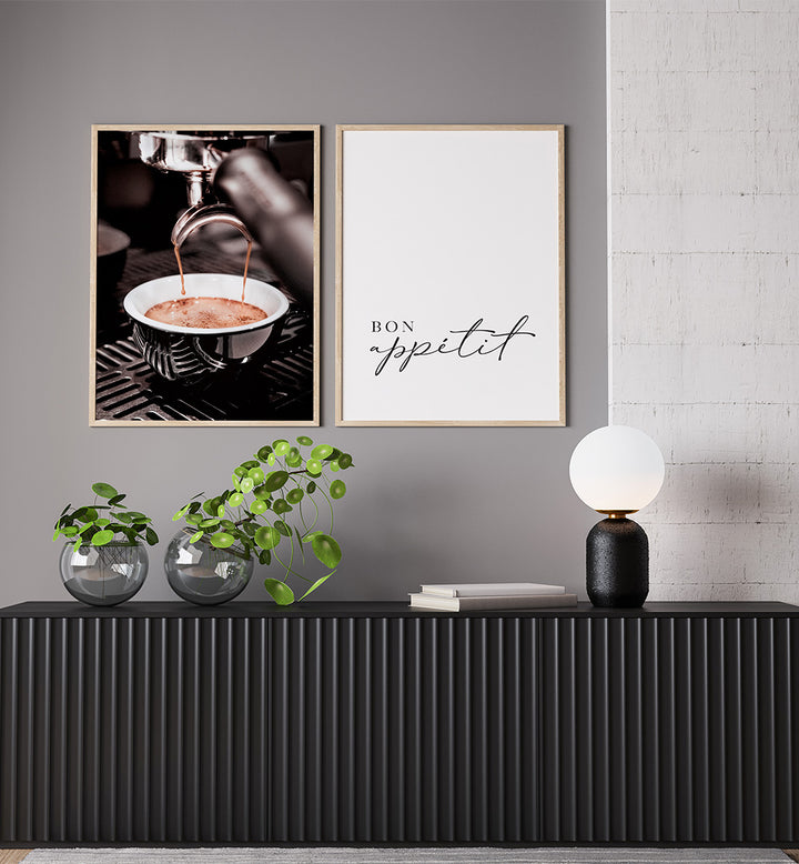 Modern interior with framed art on a gray wall, black console table, and decorative items.