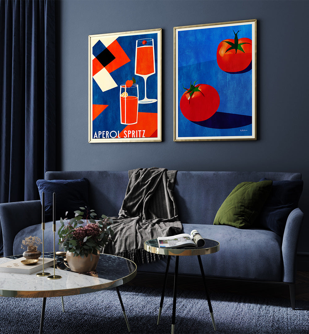 Living room with two framed artworks on a dark wall, a blue sofa, and decorative items.