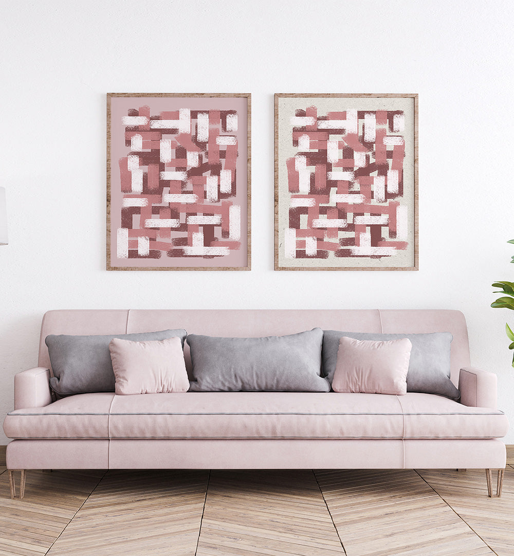 Pink sofa with decorative pillows in a room with abstract wall art.