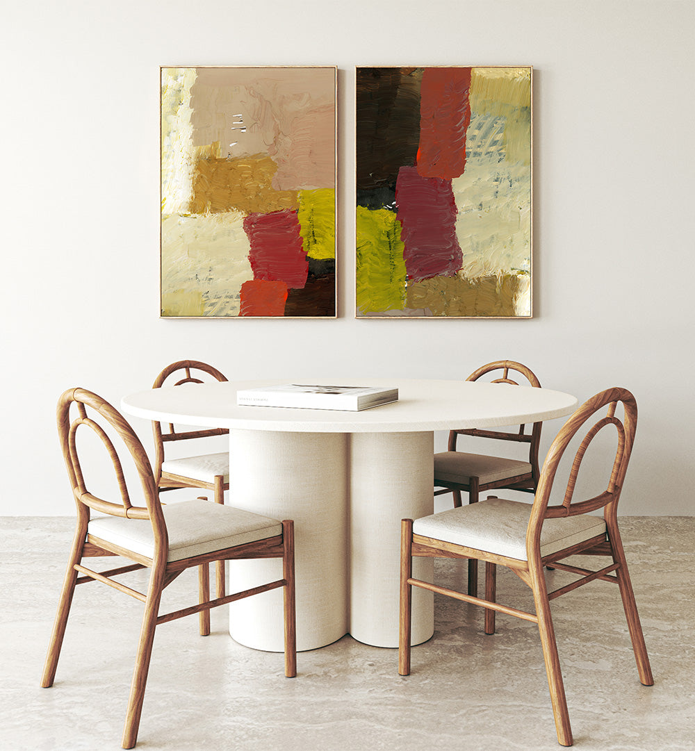 Dining area with a round table and chairs, featuring abstract art on the wall.