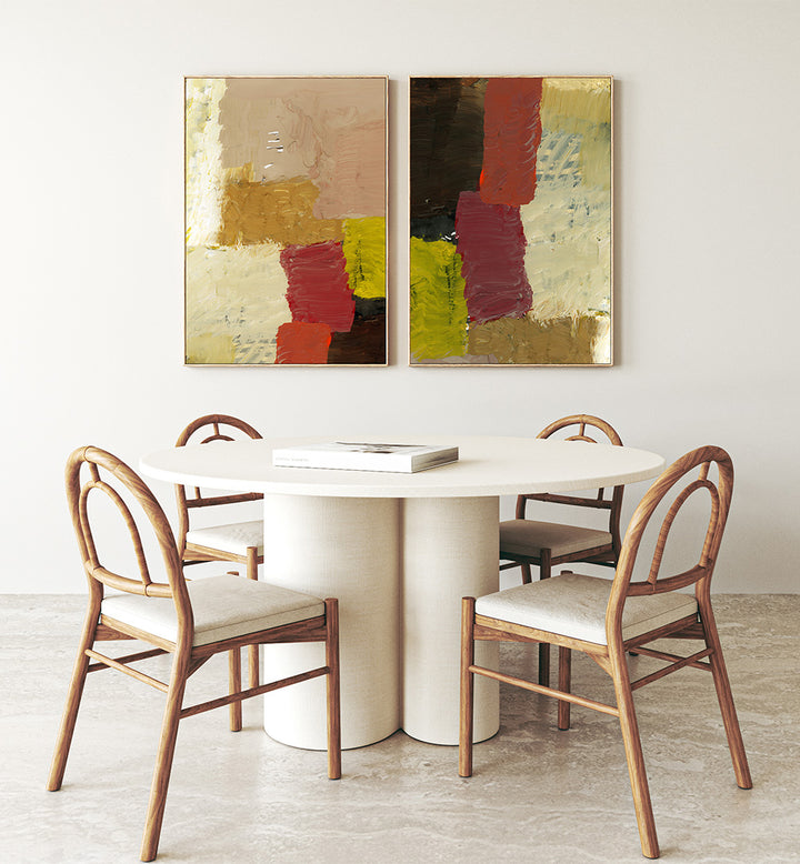Dining area with a round table and chairs, featuring abstract art on the wall.