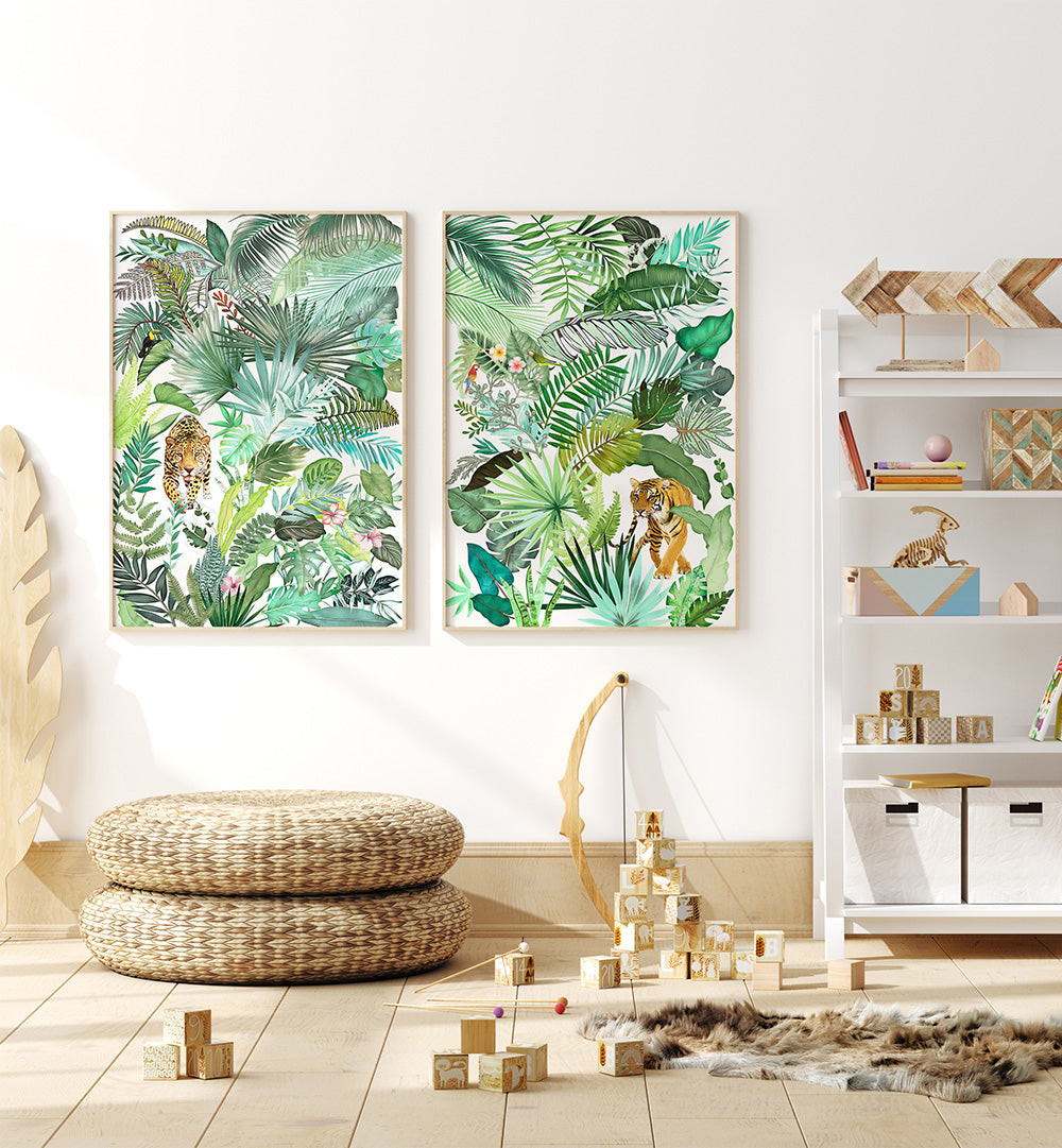 Two framed tropical leaf prints on a wall in a room with toys and furniture.