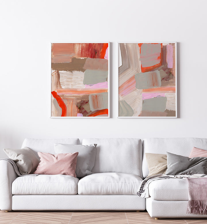 Two abstract art pieces on a wall above a white sofa.