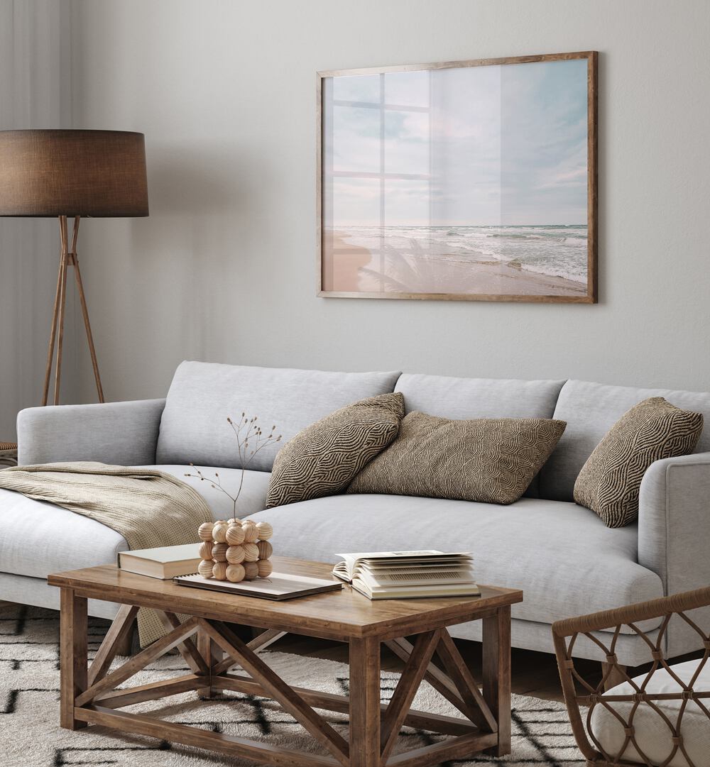 Serene living room showcasing "AT THE COAST, BEACH PAINTINGS" art, enhancing coastal charm and tranquility.
