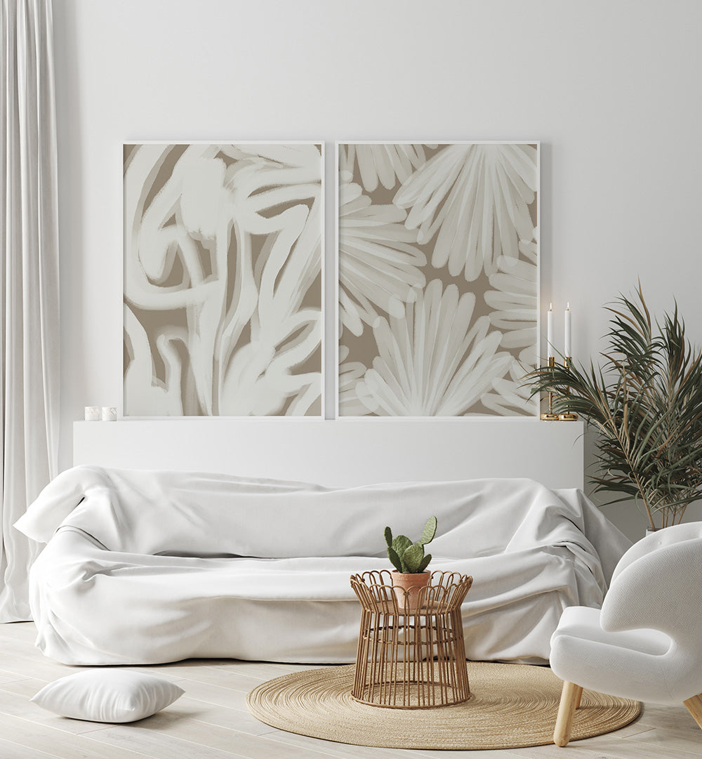 Modern living room with white sofa, decorative plants, and abstract wall art.
