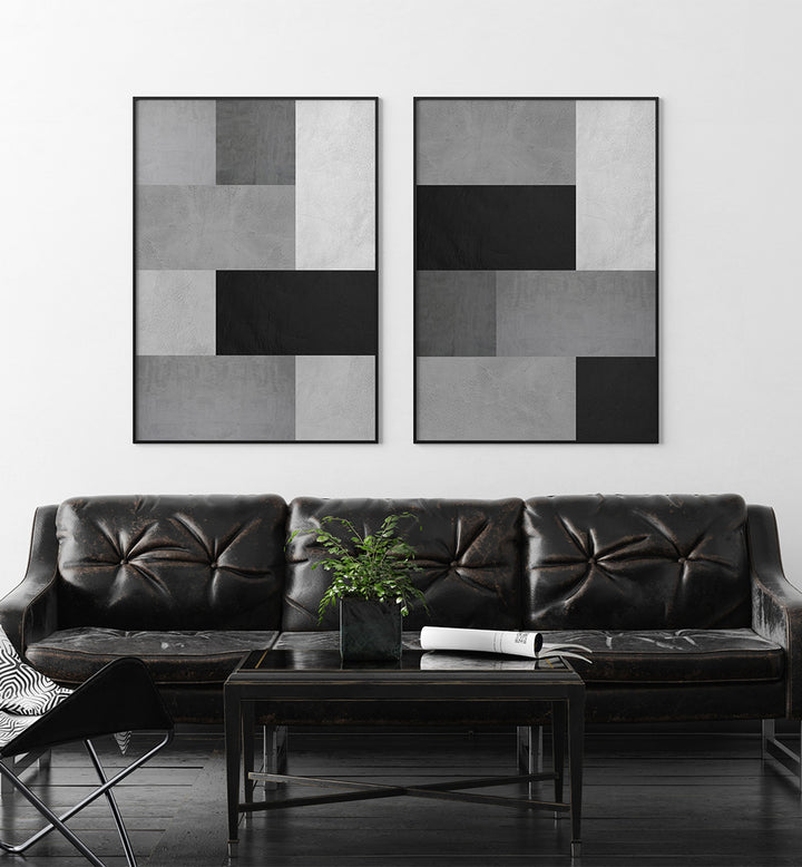 Modern living room with a black leather sofa, coffee table, and abstract wall art.