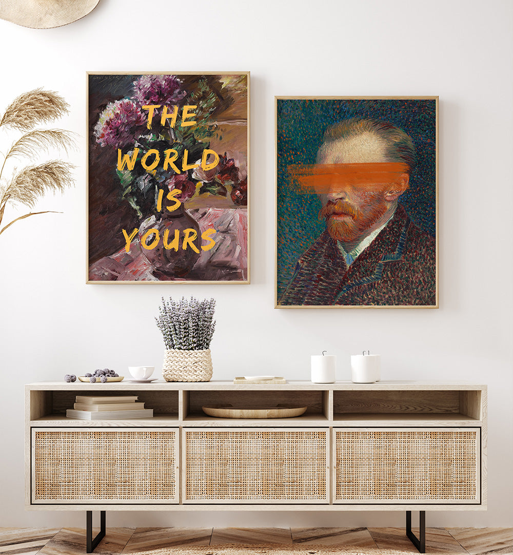 Two framed artworks on a wall above a wooden console table with decorative items.