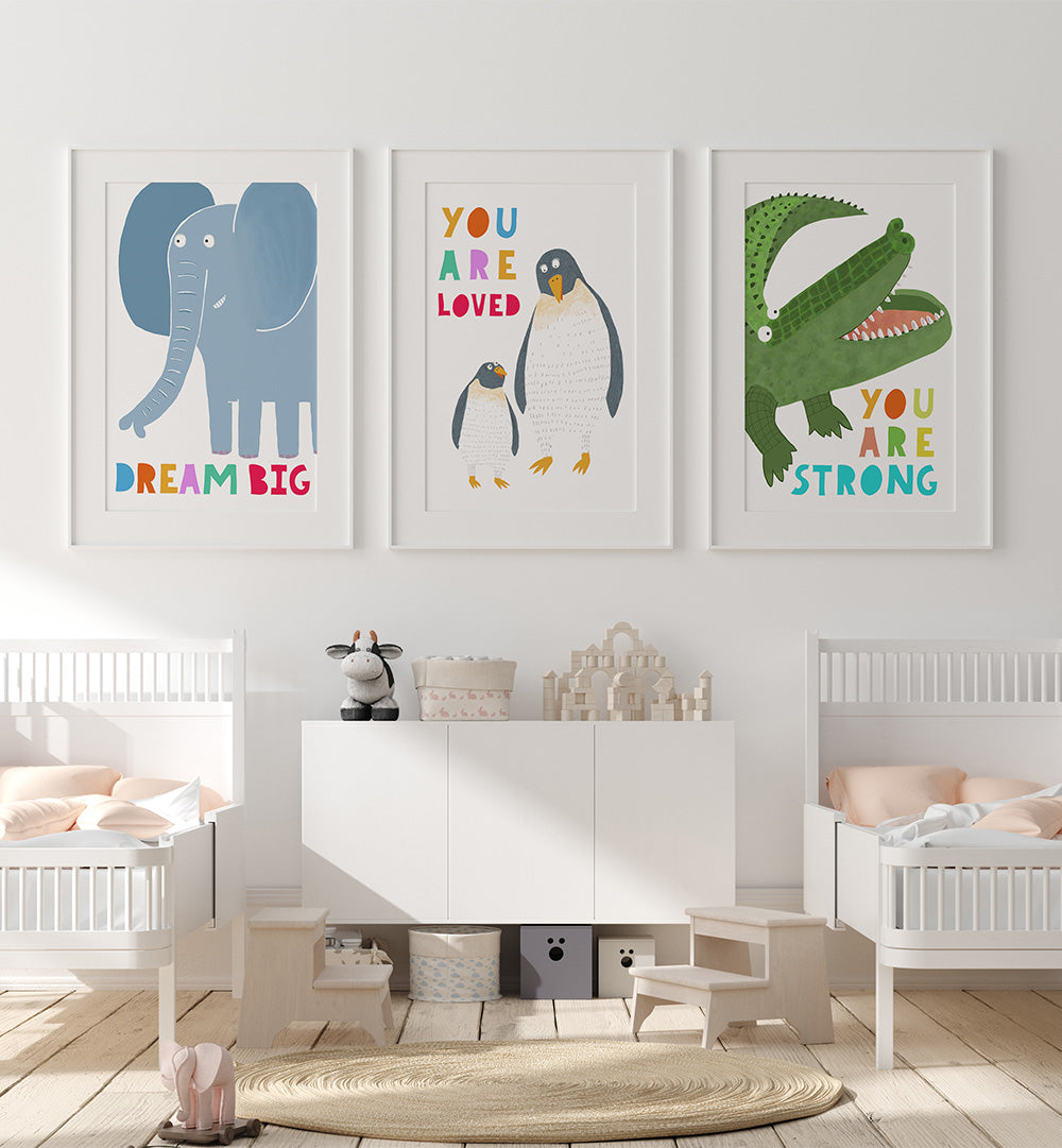 Children's room with white furniture, toys, and motivational posters on a light gray wall.