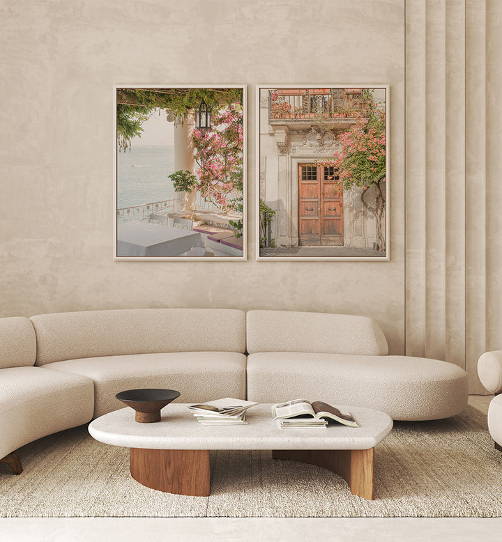 Modern living room with a beige sofa, coffee table, and wall art depicting outdoor scenes.