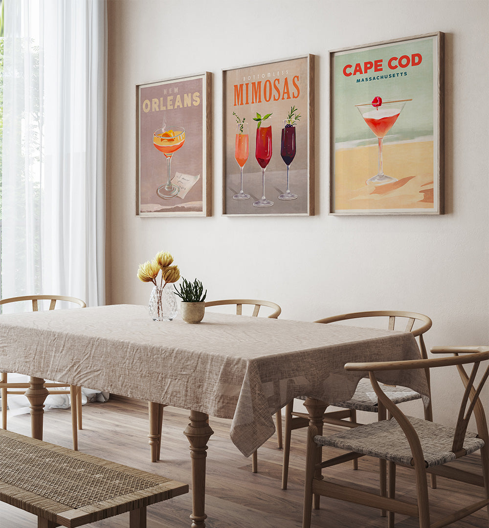 Dining room with a table and chairs, featuring framed posters on the wall.