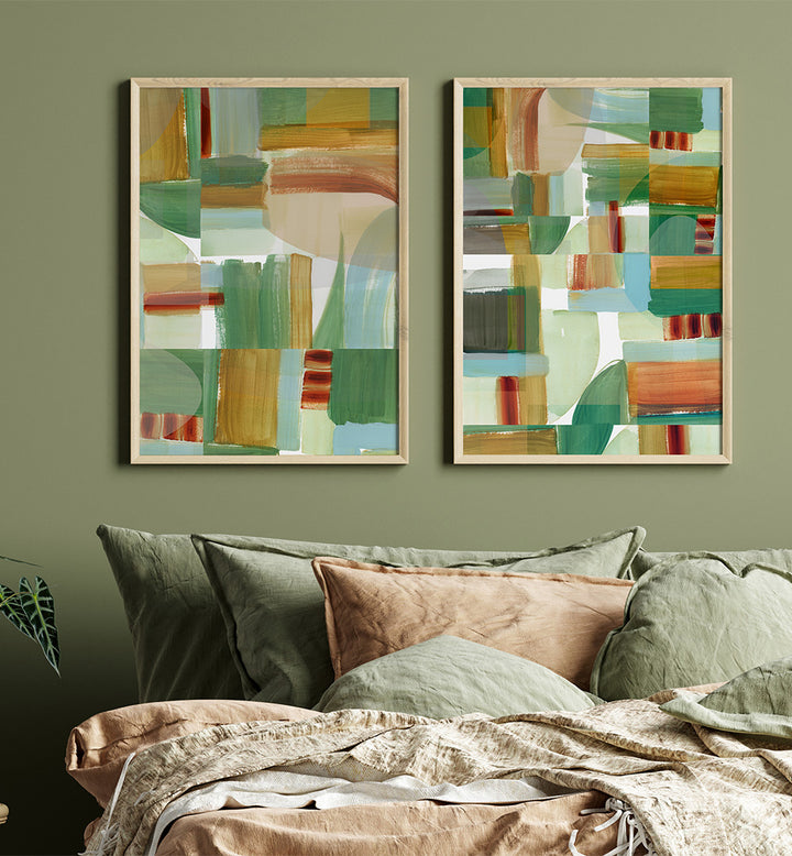 Two abstract art pieces on a wall above a bed with green and brown bedding.
