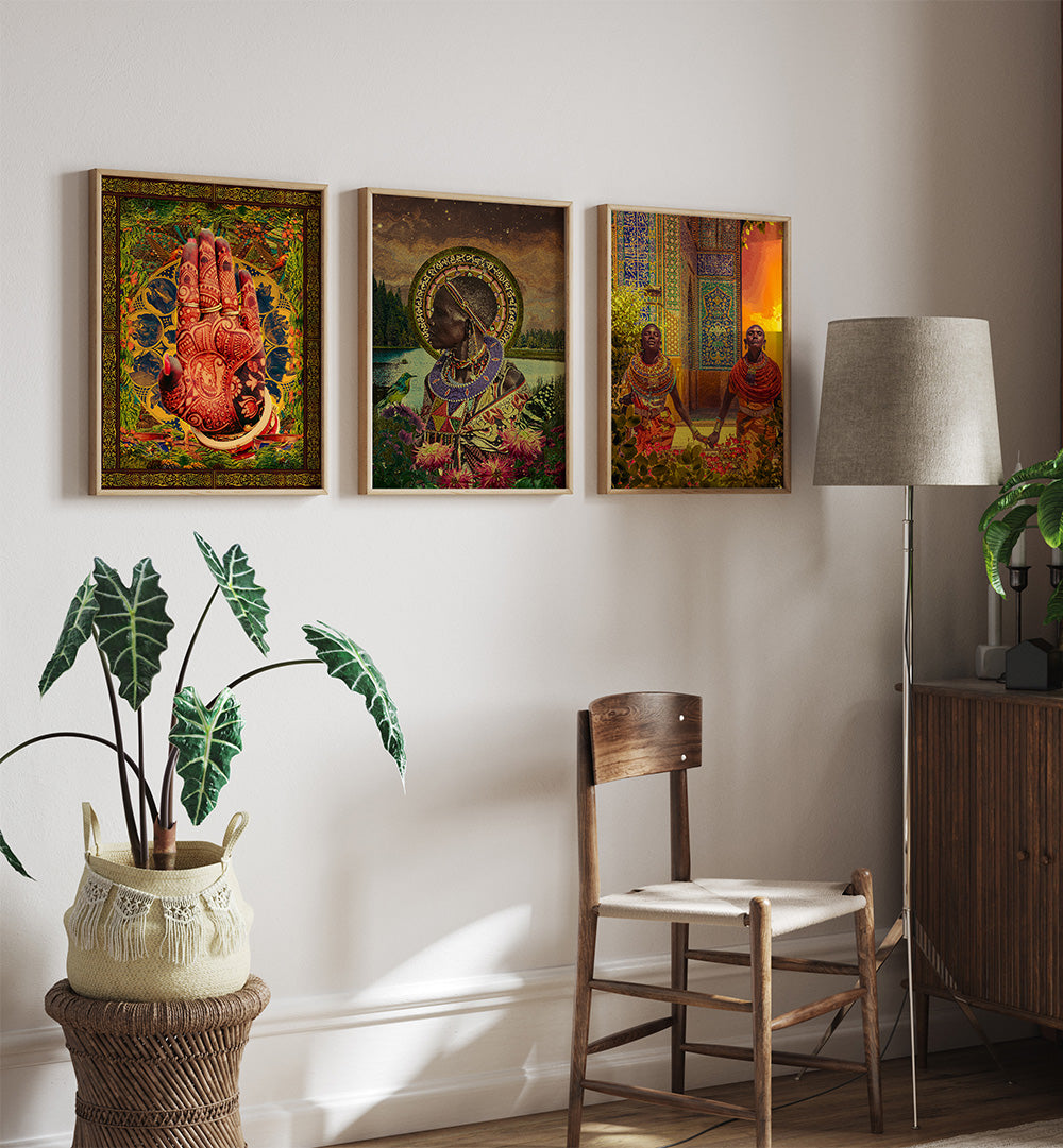 Three colorful framed artworks on a wall above a wooden chair and plant.