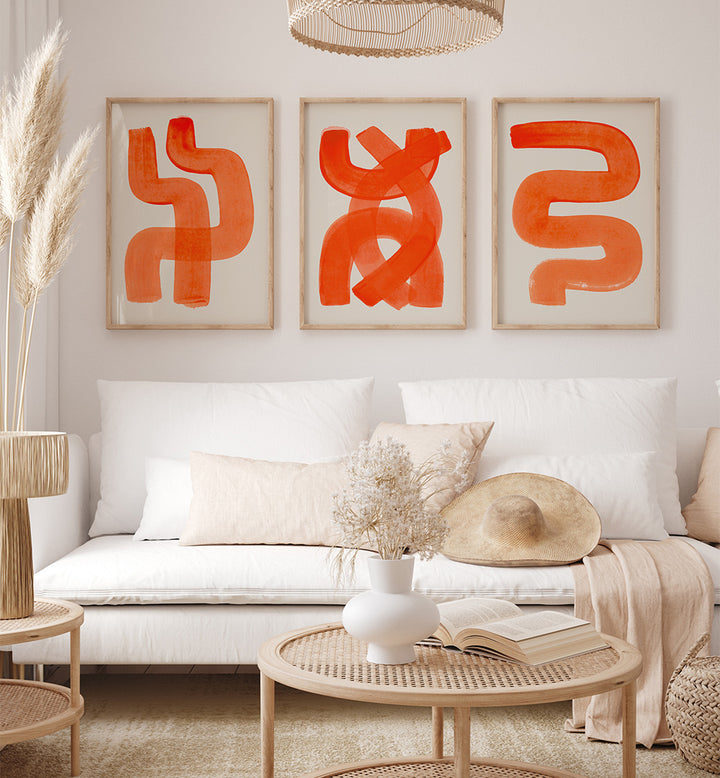 Modern living room with abstract orange artwork on the wall, white sofa, and decorative items.