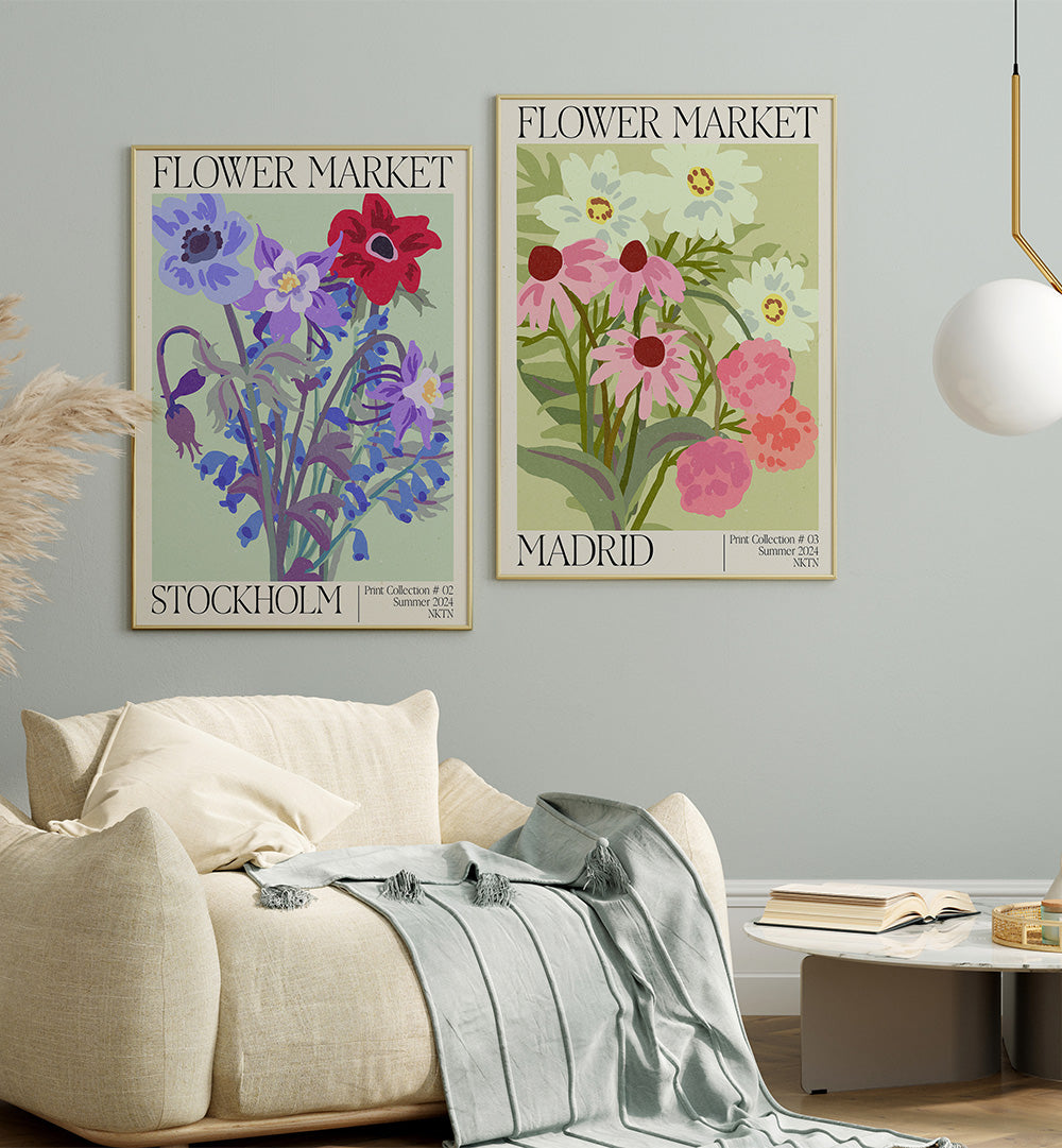 Two floral posters titled 'Flower Market Stockholm' and 'Flower Market Madrid' on a wall above a sofa.
