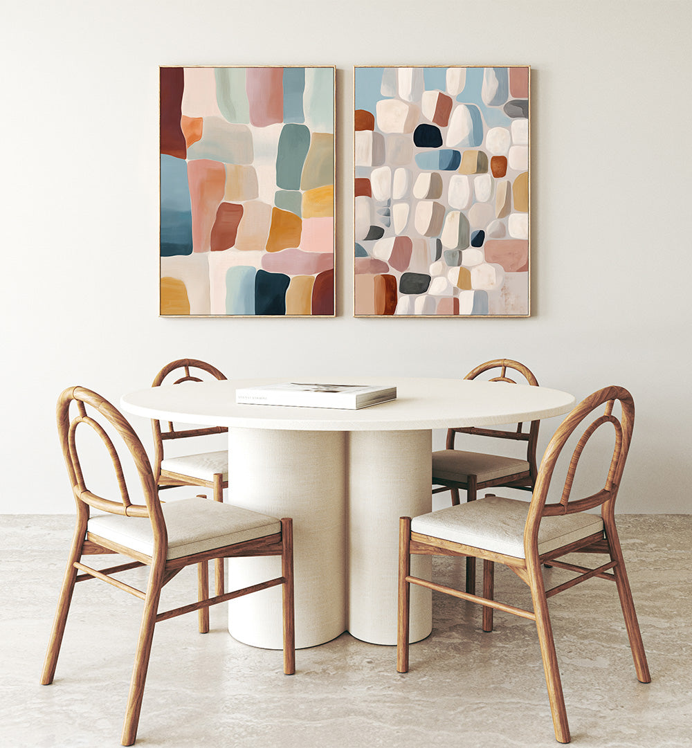 Dining area with a round table and chairs, featuring abstract wall art on the wall.