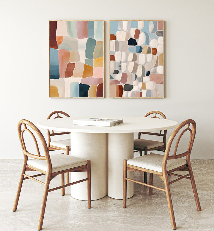 Dining area with a round table and chairs, featuring abstract wall art on the wall.