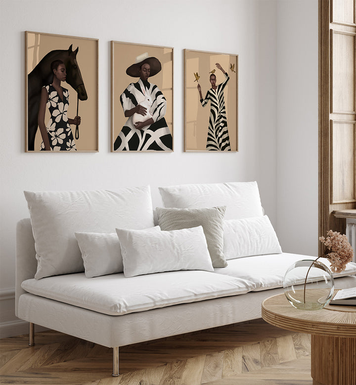 Modern living room with a white sofa, wooden coffee table, and three framed artworks on the wall.
