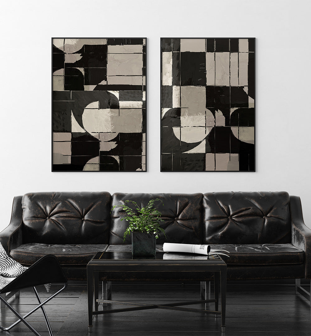 Two abstract art pieces hanging above a black leather sofa in a living room.