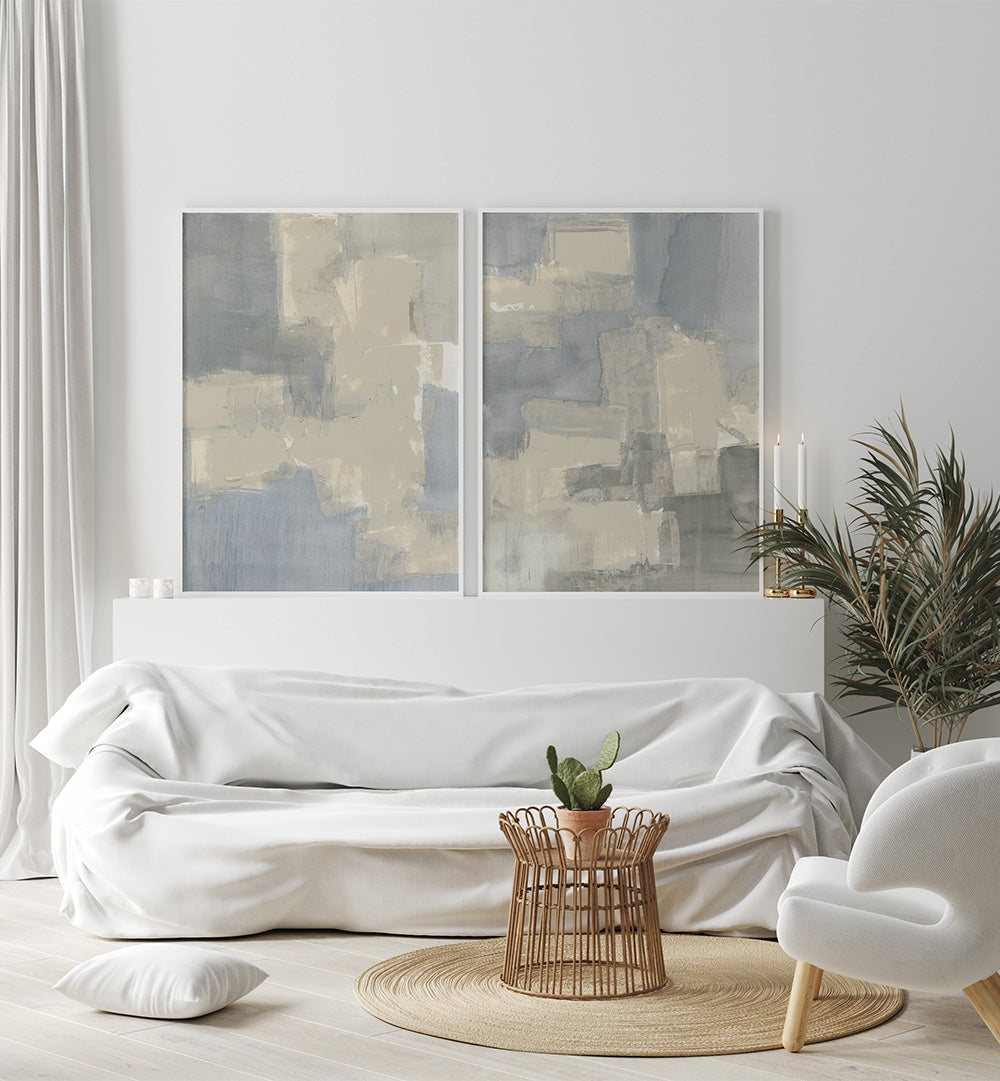 Modern living room with a white sofa, abstract art, and a plant.