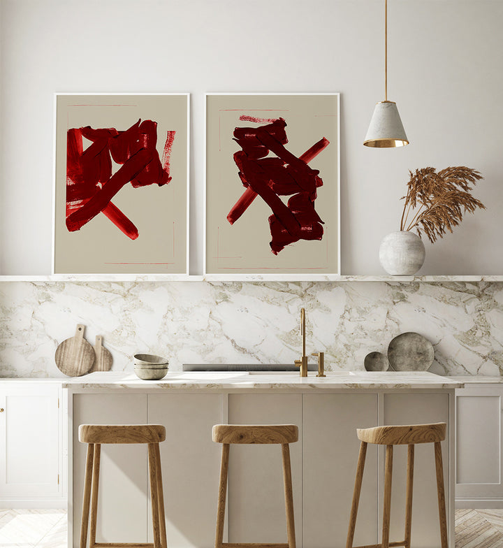Modern kitchen with abstract red artworks on the wall, marble countertop, and wooden stools.