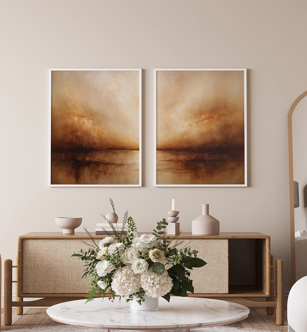 Two abstract paintings on a wall above a wooden console table with decorative items.