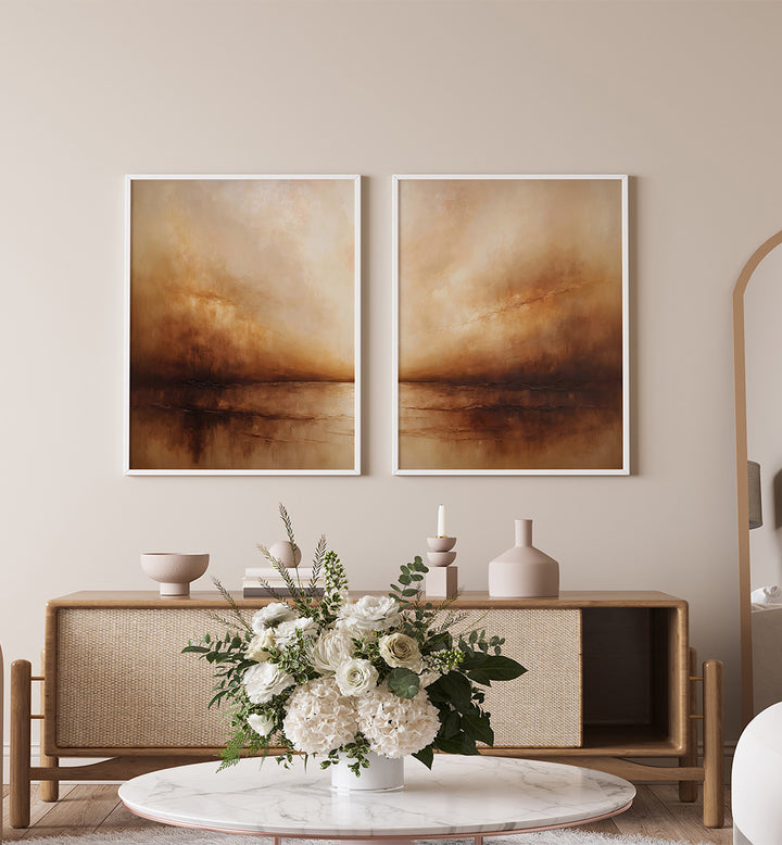 Two abstract paintings on a wall above a wooden console table with decorative items.