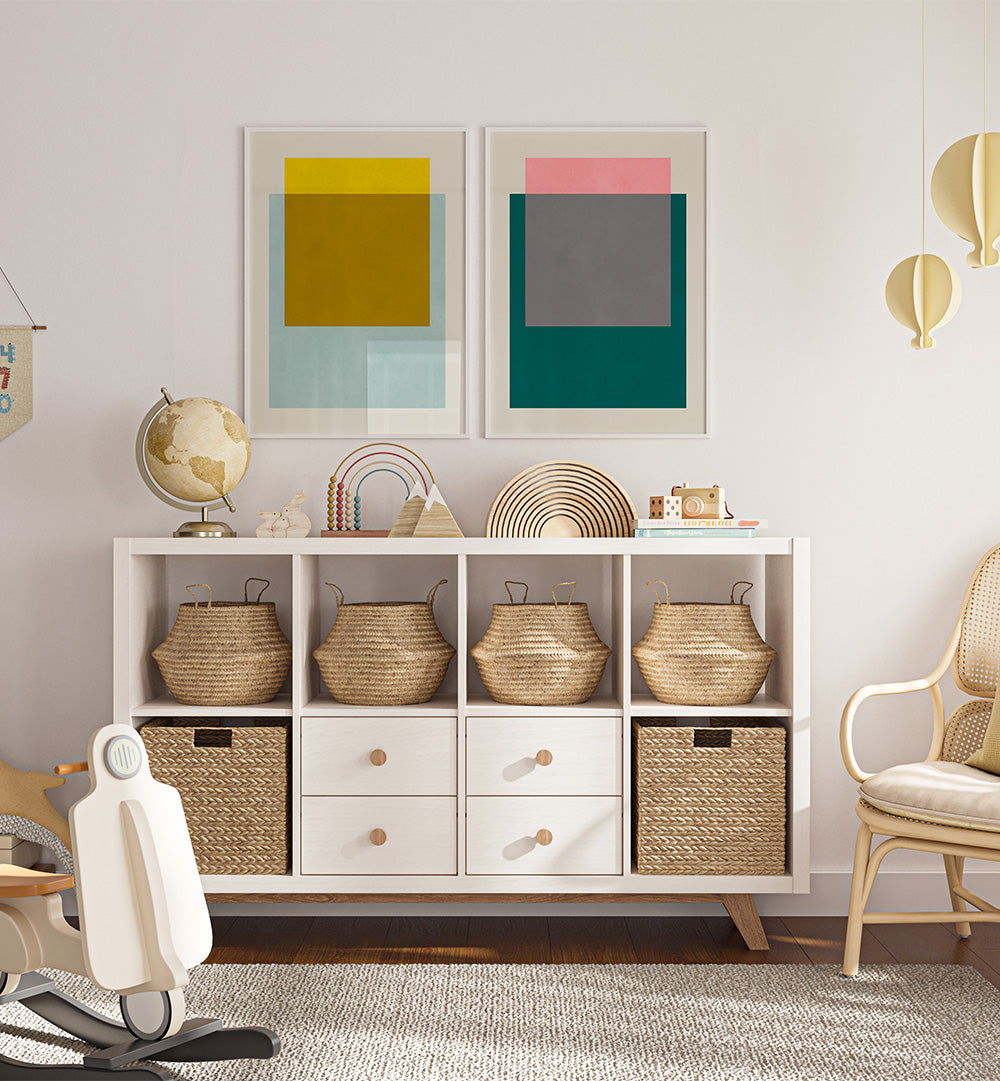 White storage unit with wicker baskets and decorative items in a room with abstract art on the wall.
