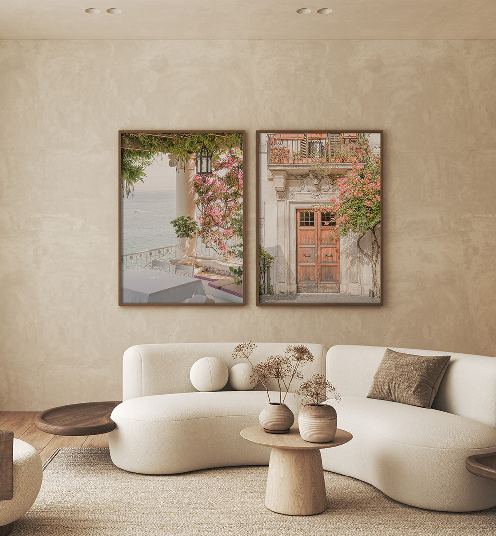 Modern living room with a white sofa, decorative pillows, and two framed artworks on the wall.