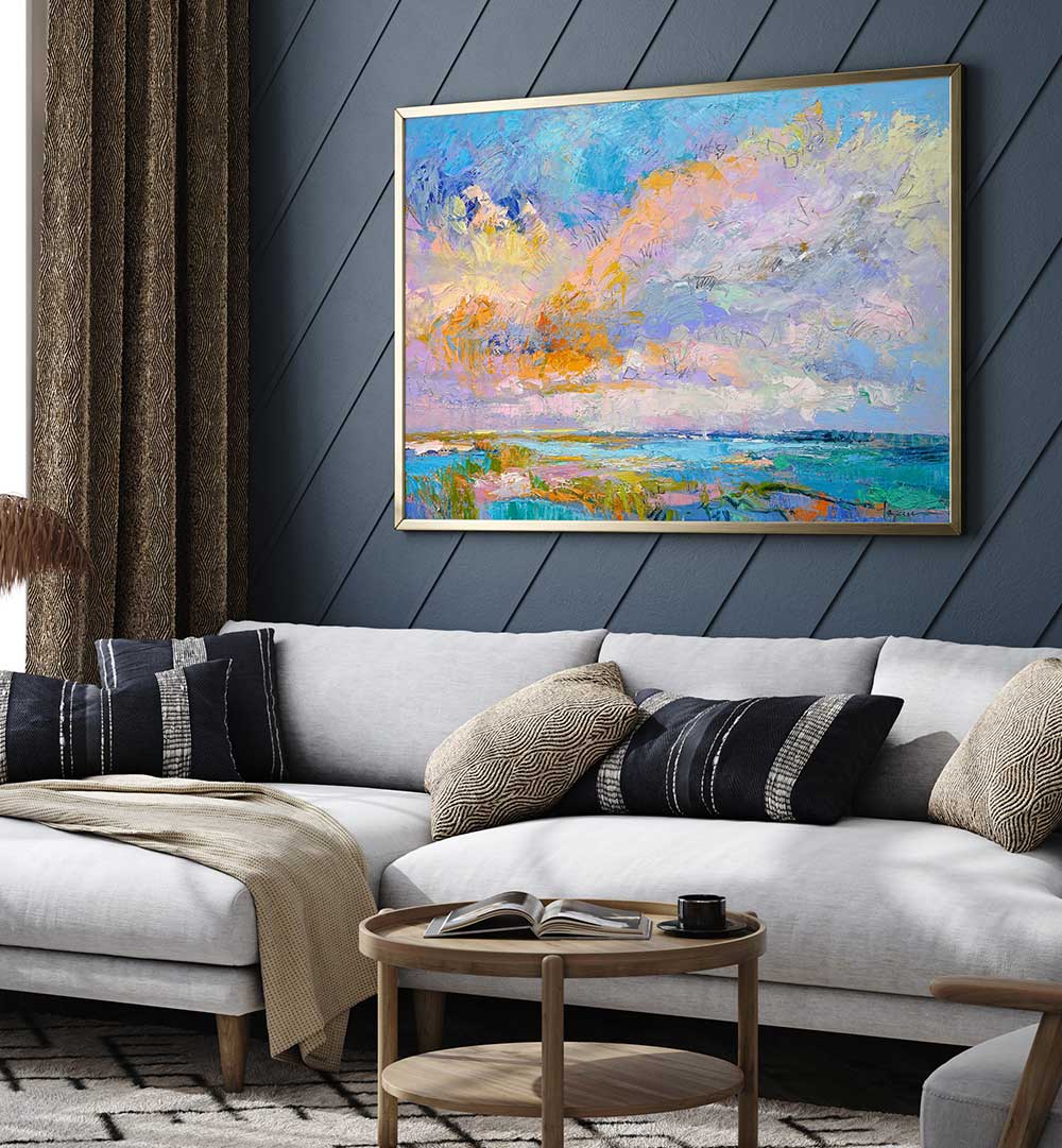 COLORFUL , LANDSCAPE PAINTINGS — framed abstract coastal landscape with pastel skies hanging above a modern living room sofa