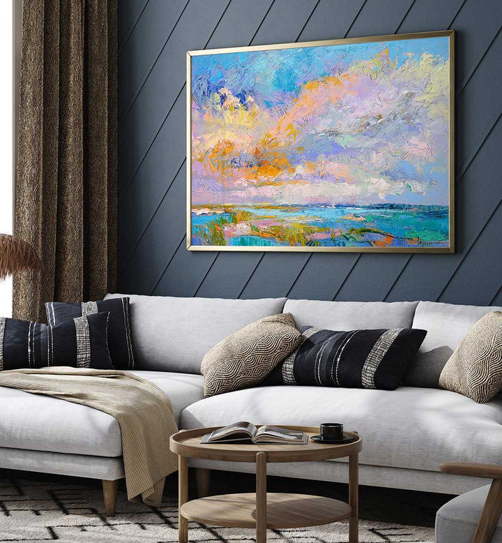 COLORFUL , LANDSCAPE PAINTINGS — framed abstract coastal landscape with pastel skies hanging above a modern living room sofa