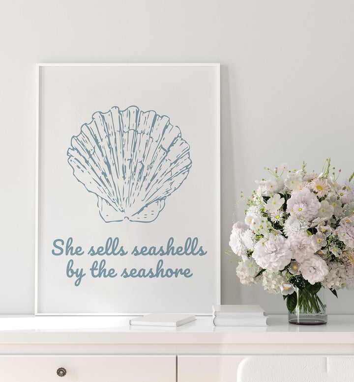 Elegant SHE SELLS SEASHELLS, BEACH PAINTINGS showcased with a seashell illustration and fresh flowers, perfect for beach lovers.