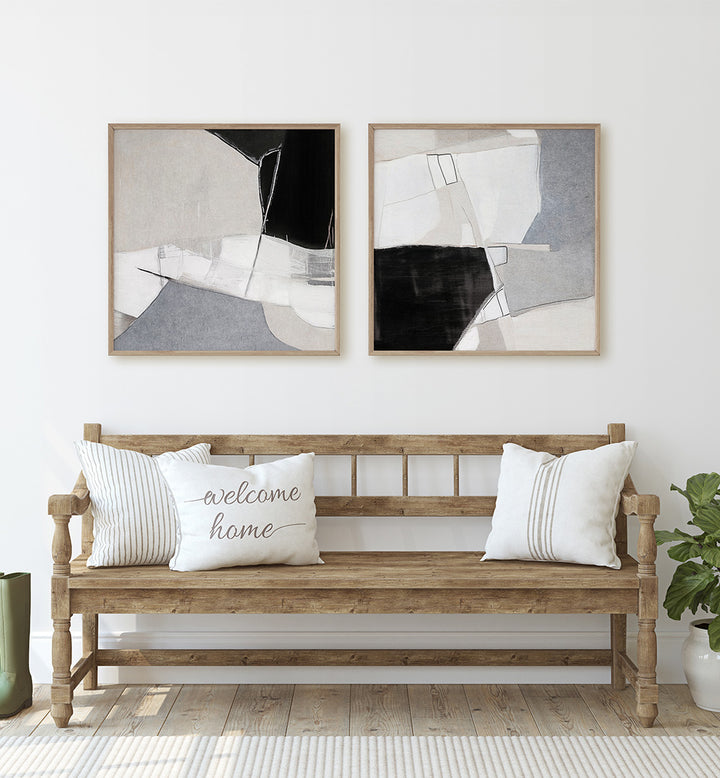 Wooden bench with decorative pillows and abstract art on a white wall