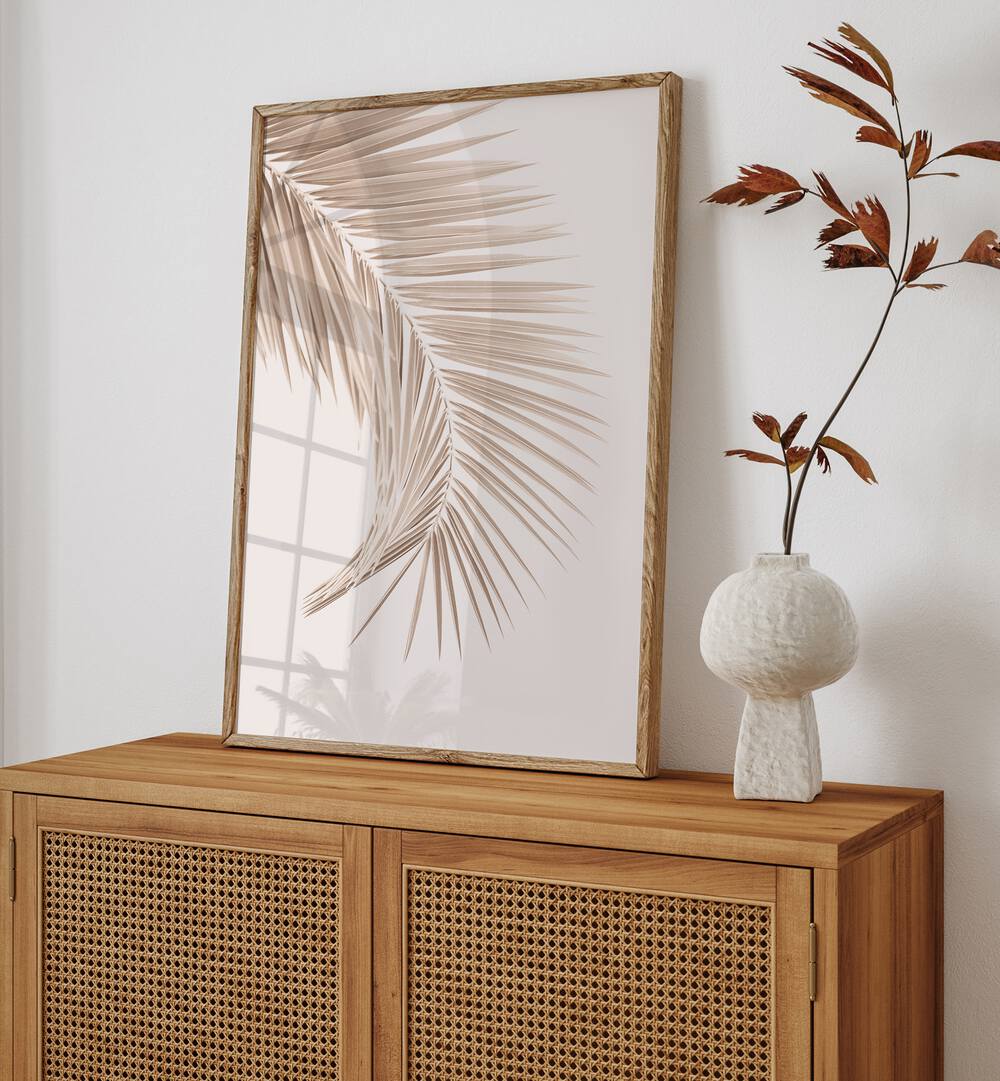 Elegant TAN LEAF II, FLORAL FLOWER PAINTINGS displayed on a wooden cabinet, enhancing modern home decor aesthetics.
